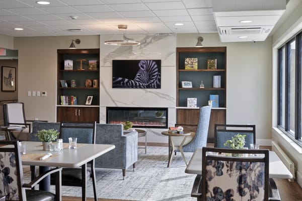Bright common area with seating and a fireplace