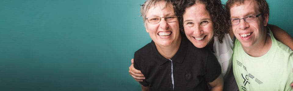 Three smiling individuals posing together