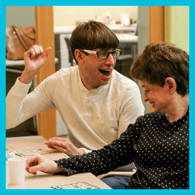 Residents enjoying a game together in an activity room