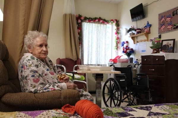 Resident enjoying a snack in a cozy room