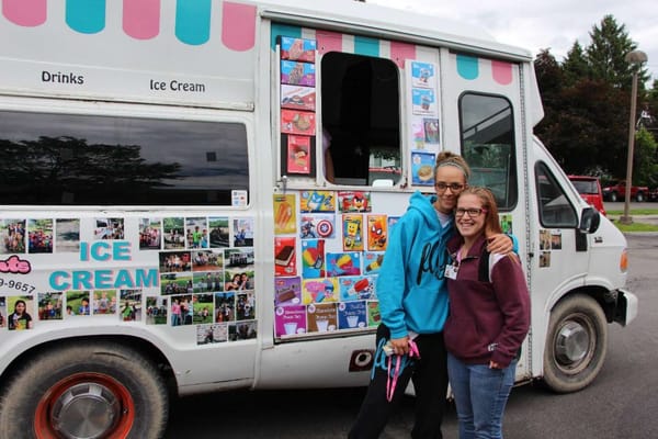 Staff and residents enjoying drinks at an ice cream truck