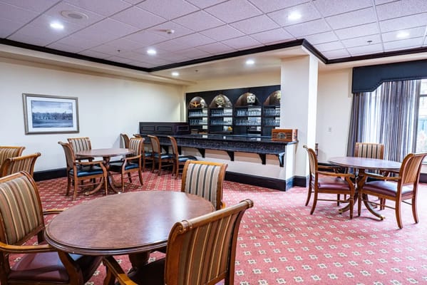 Common area with tables and chairs in a cozy setting