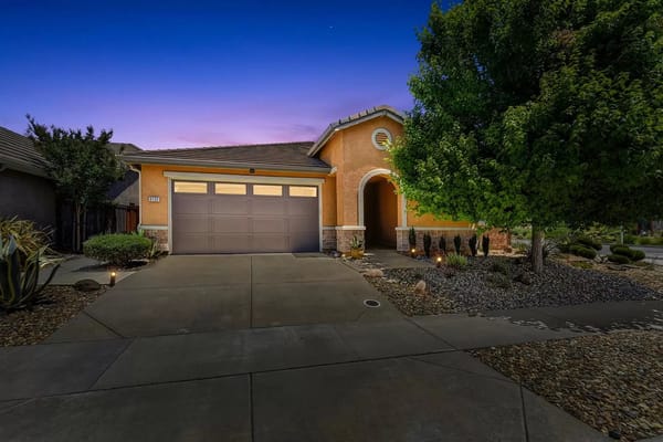 Exterior view of a residential building with landscaped yard