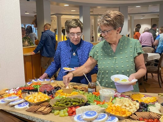Residents enjoying a food spread at a social event