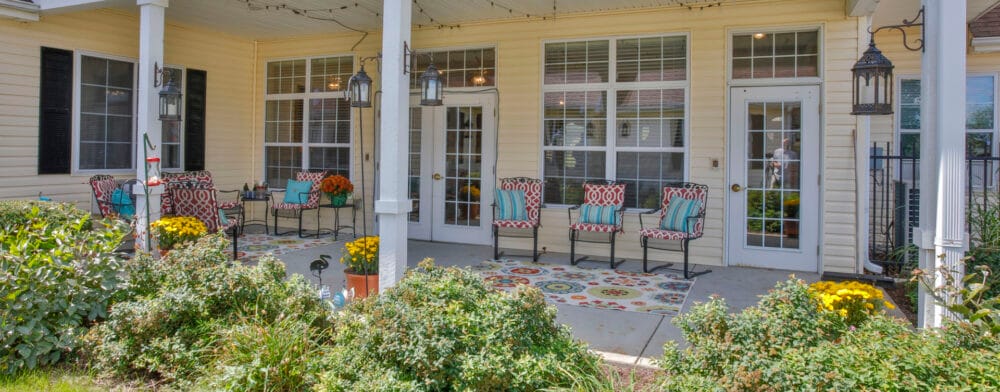 Outdoor seating area with colorful chairs and flowers
