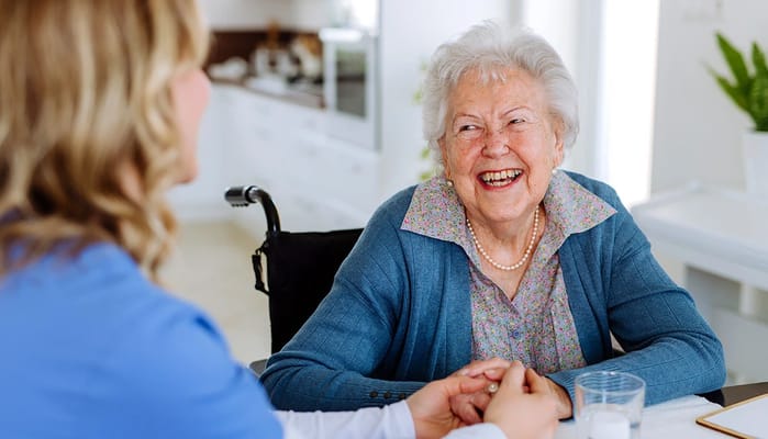 Happy resident engaging with staff in a common area