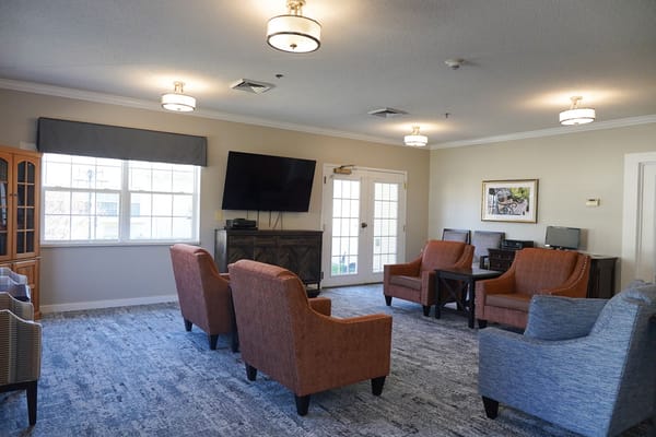 Bright common area with seating and a television