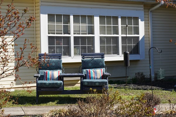 Outdoor seating area with chairs and pillows