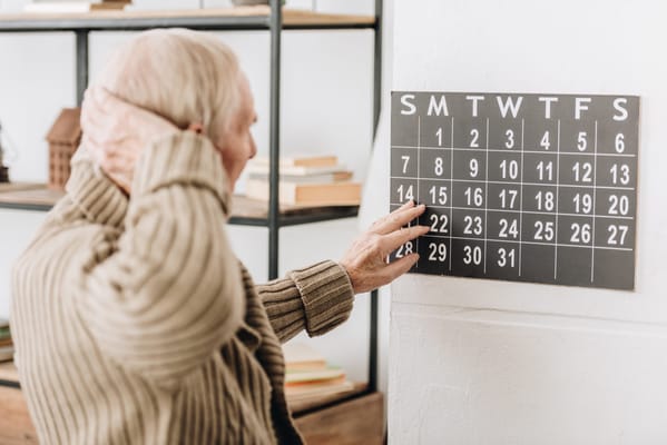 A resident interacting with a calendar in a common area