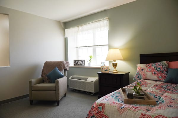 Cozy resident bedroom with armchair and decor