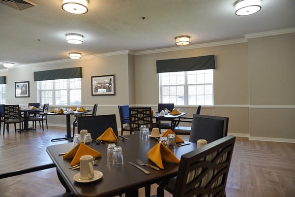 Dining area set up for meal service with tables and decor
