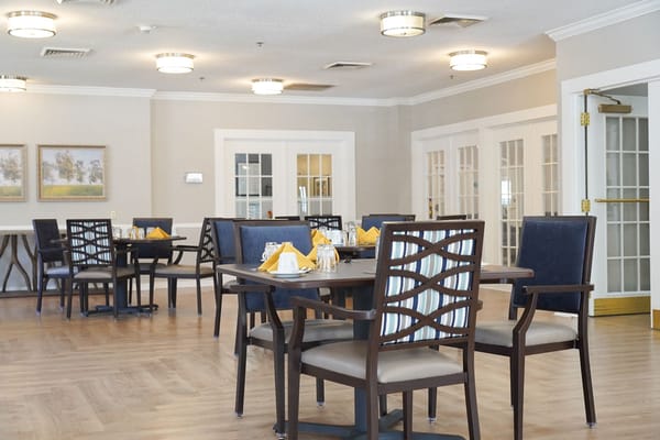 Dining area set up for residents in a bright location