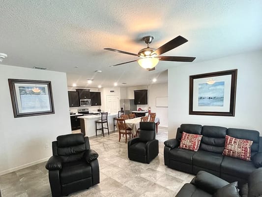 Bright common area with seating and kitchen in the background