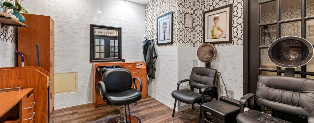 Hair salon interior with styling chairs and a hair dryer station