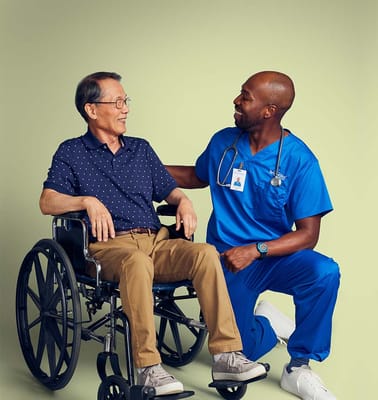 Healthcare worker interacting with a resident in a wheelchair