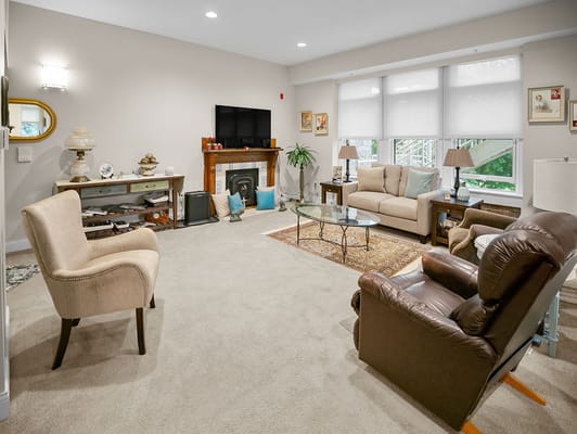 Interior view of a cozy common area with seating and television