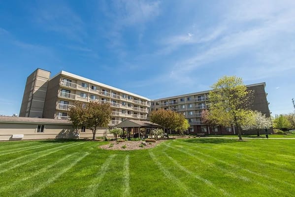 Exterior view of Friendship House Community with landscaped grounds