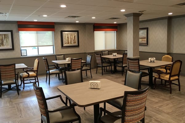 Dining area with tables and chairs in a bright interior