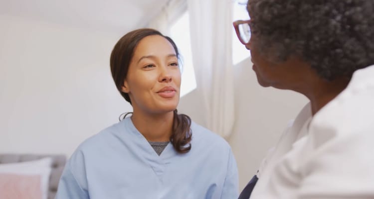 Caregiver engaging with a resident in a bright room