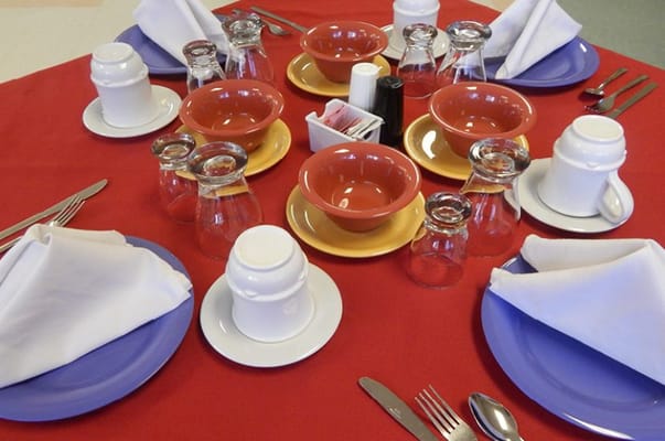 Dining table set up with plates and glasses