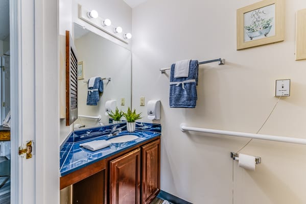 Well-lit bathroom with vanity and accessible features