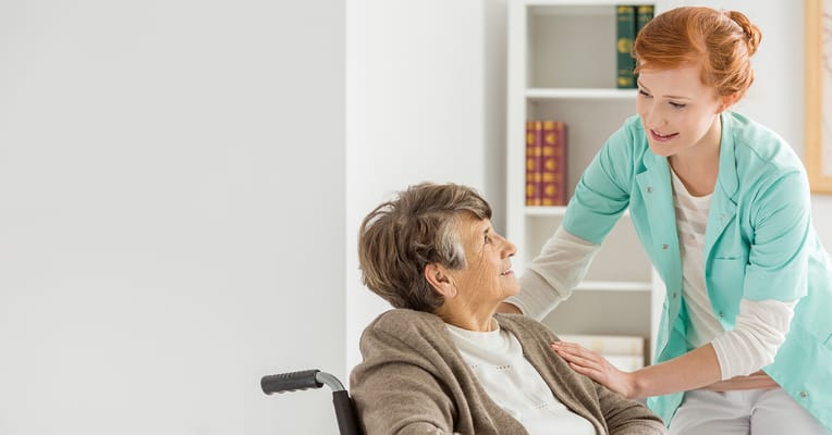 A caregiver assisting an elderly resident in a facility