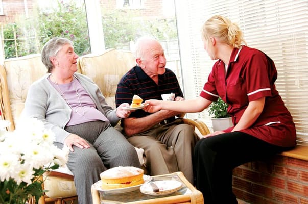 Residents enjoying tea and cake in a common area
