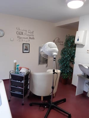 Interior view of a salon with a hair dryer and decor