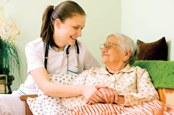 Nurse smiling with an elderly resident