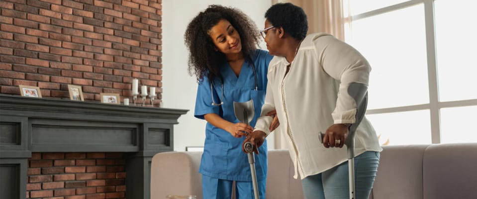 Caregiver assisting a resident in a cozy living room