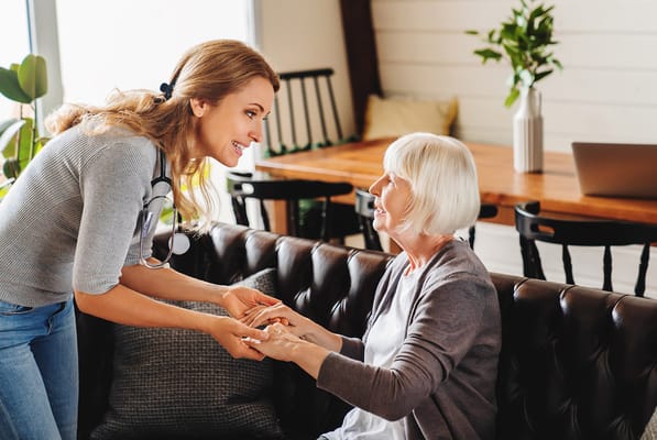Staff member interacting with a resident in a cozy lounge