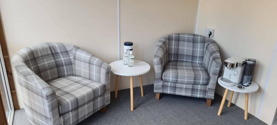 Comfortable seating area with two plaid chairs