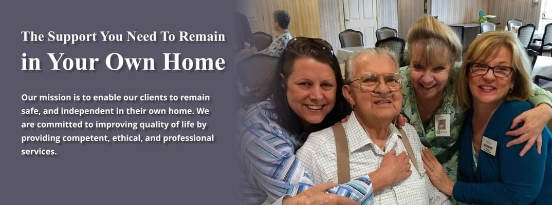 Senior resident with staff members in a common area