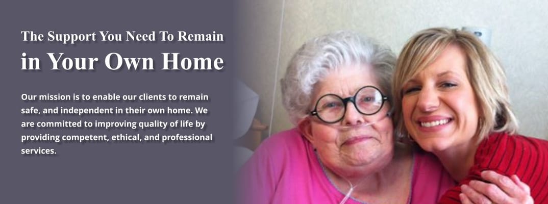 A caregiver smiling with a senior resident at home