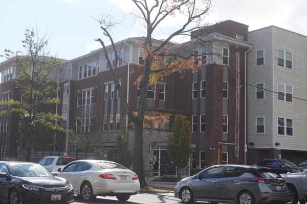 Exterior of Maple Heights Senior Living facility with vehicles parked in front.