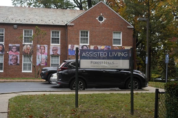 Exterior view of assisted living facility with signage