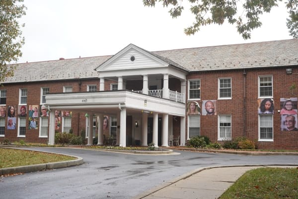Front entrance of assisted living facility with resident photos