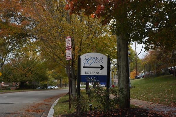Sign for Grand Oaks Assisted Living with autumn scenery