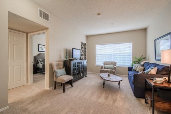 Living room with a sofa, coffee table, and television