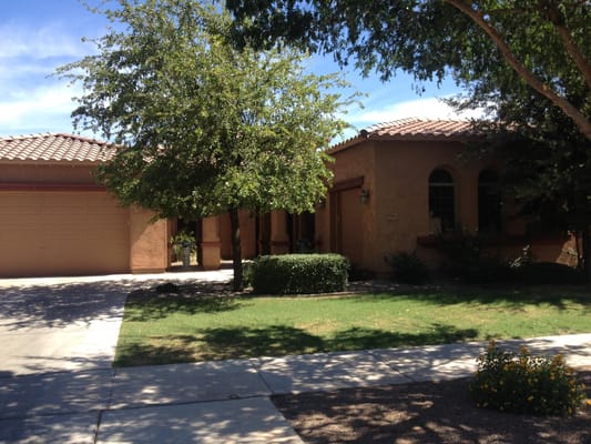 Exterior view of A Caring Manor I with landscaped yard and garage