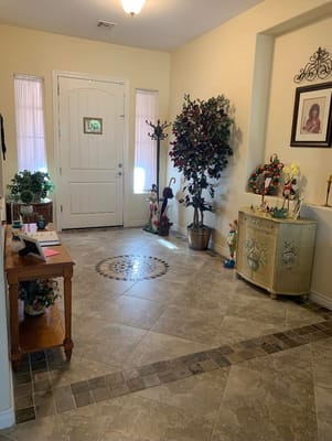 Bright entryway with decorative plants and artwork