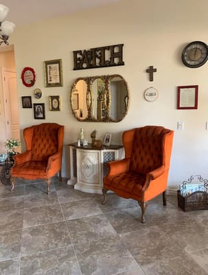 Two orange armchairs in a decorated sitting area
