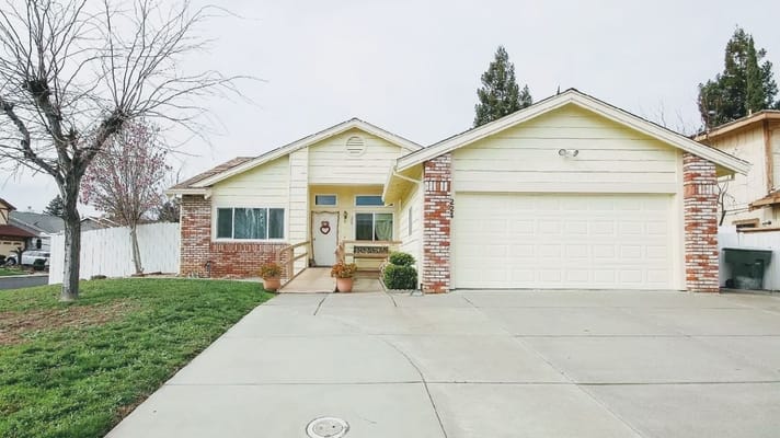 Exterior view of a single-family home with a yard