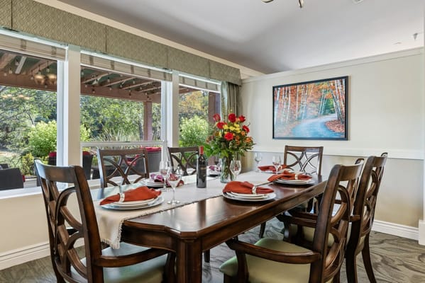 Dining room with a beautifully set table and flowers