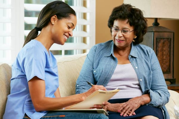 A caregiver and a resident discussing together