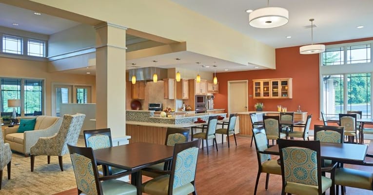 Bright common area with seating and dining tables