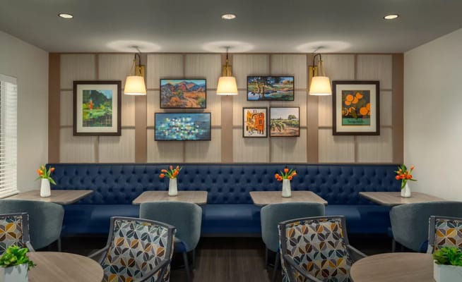 Interior dining area with decorative artwork and seating