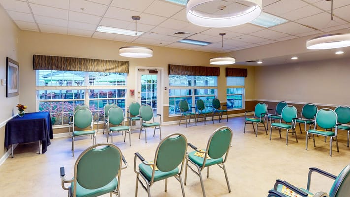 Bright activity room with chairs arranged for a gathering