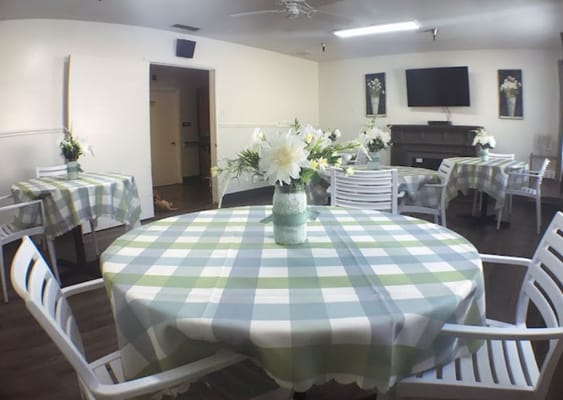 Bright dining area with floral centerpieces and checkered tablecloths