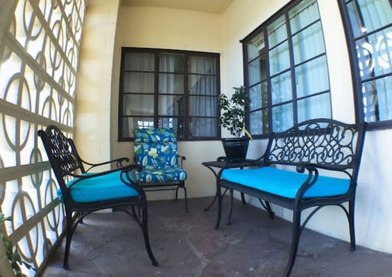 A cozy outdoor seating area with floral chairs